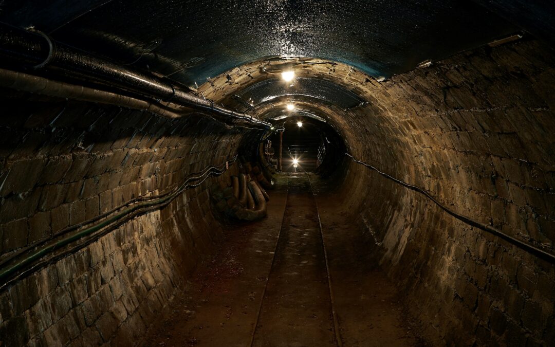 Photo: A dark underground mine tunnel.