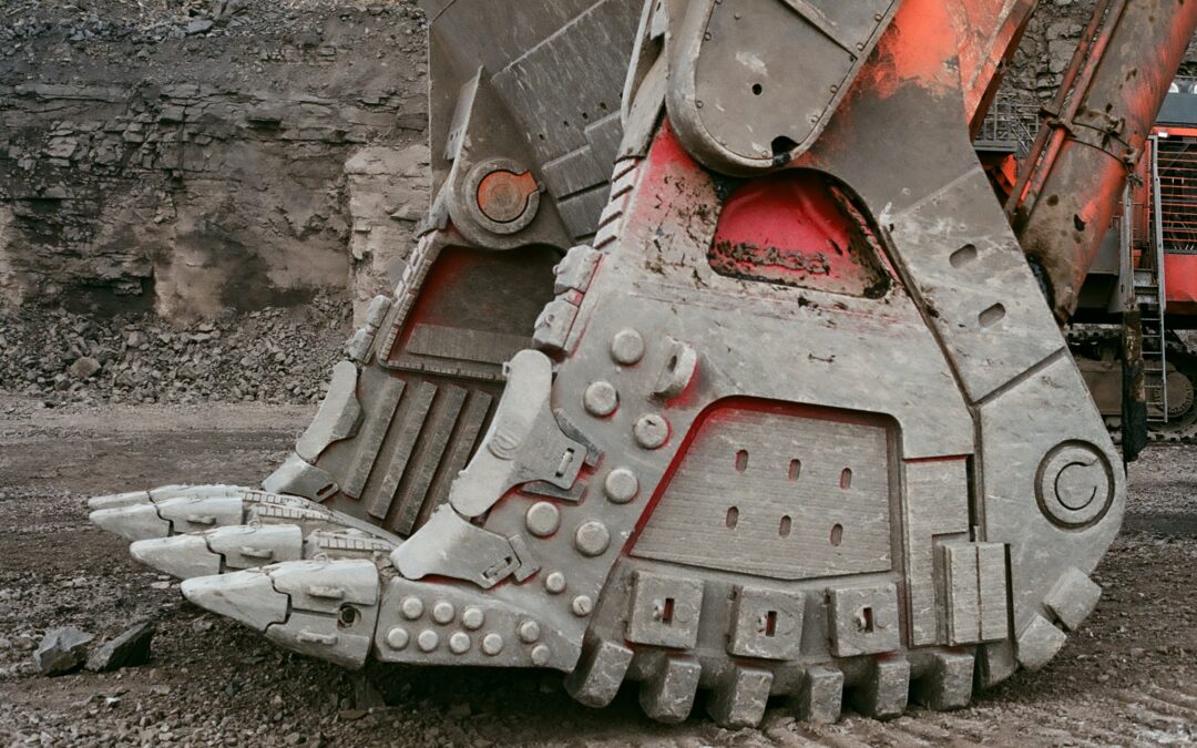 Close up of orange digger covered in dust. (Photo)