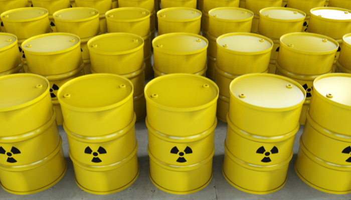 Rows of yellow containers of uranium with radioactive symbol printed on them